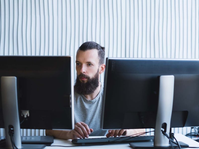 guy-with-two-screens.1400px